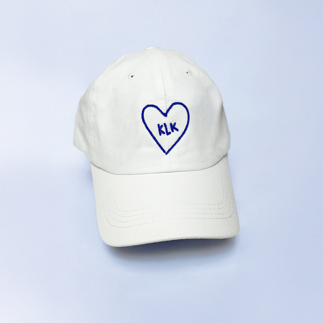 White Baseball Cap with Navy KLK Heart Embroidery