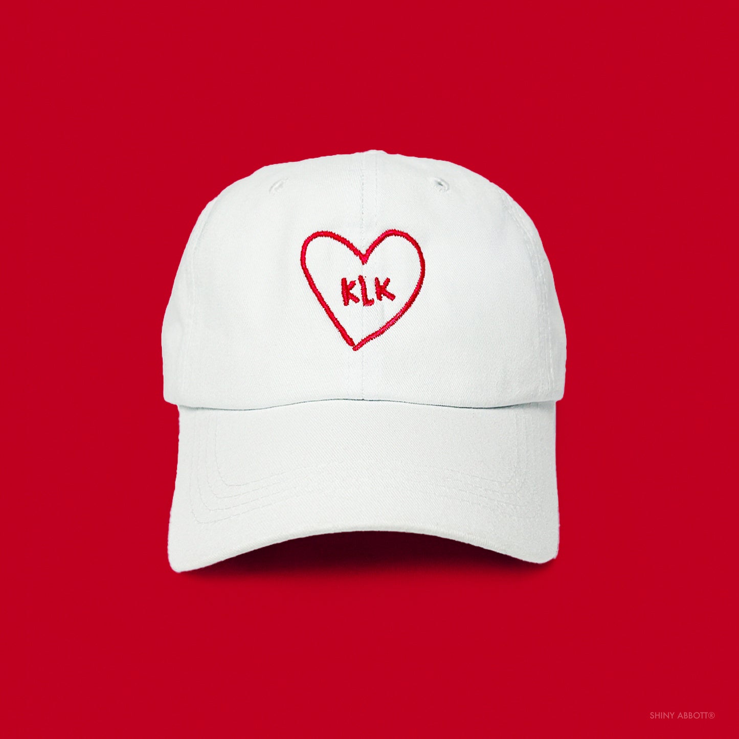 White Baseball Cap with Red KLK Heart Embroidery