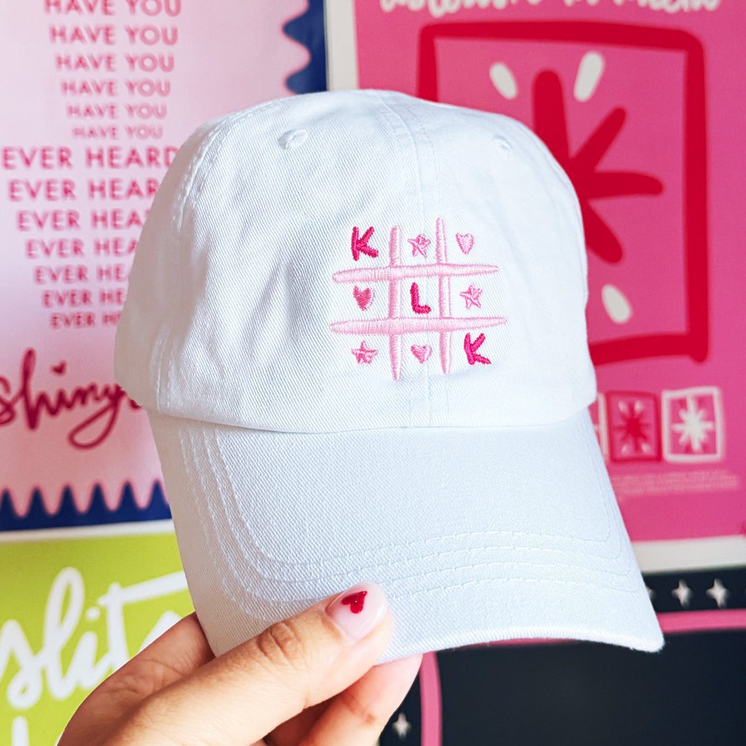 White Baseball Cap with Pink KLK Game Embroidery