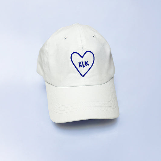 White Baseball Cap with Navy KLK Heart Embroidery