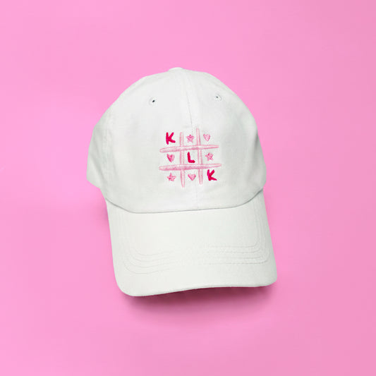 White Baseball Cap with Pink KLK Game Embroidery